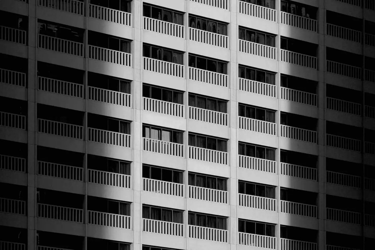 A modern building facade with repeating windows and strong architectural lines.